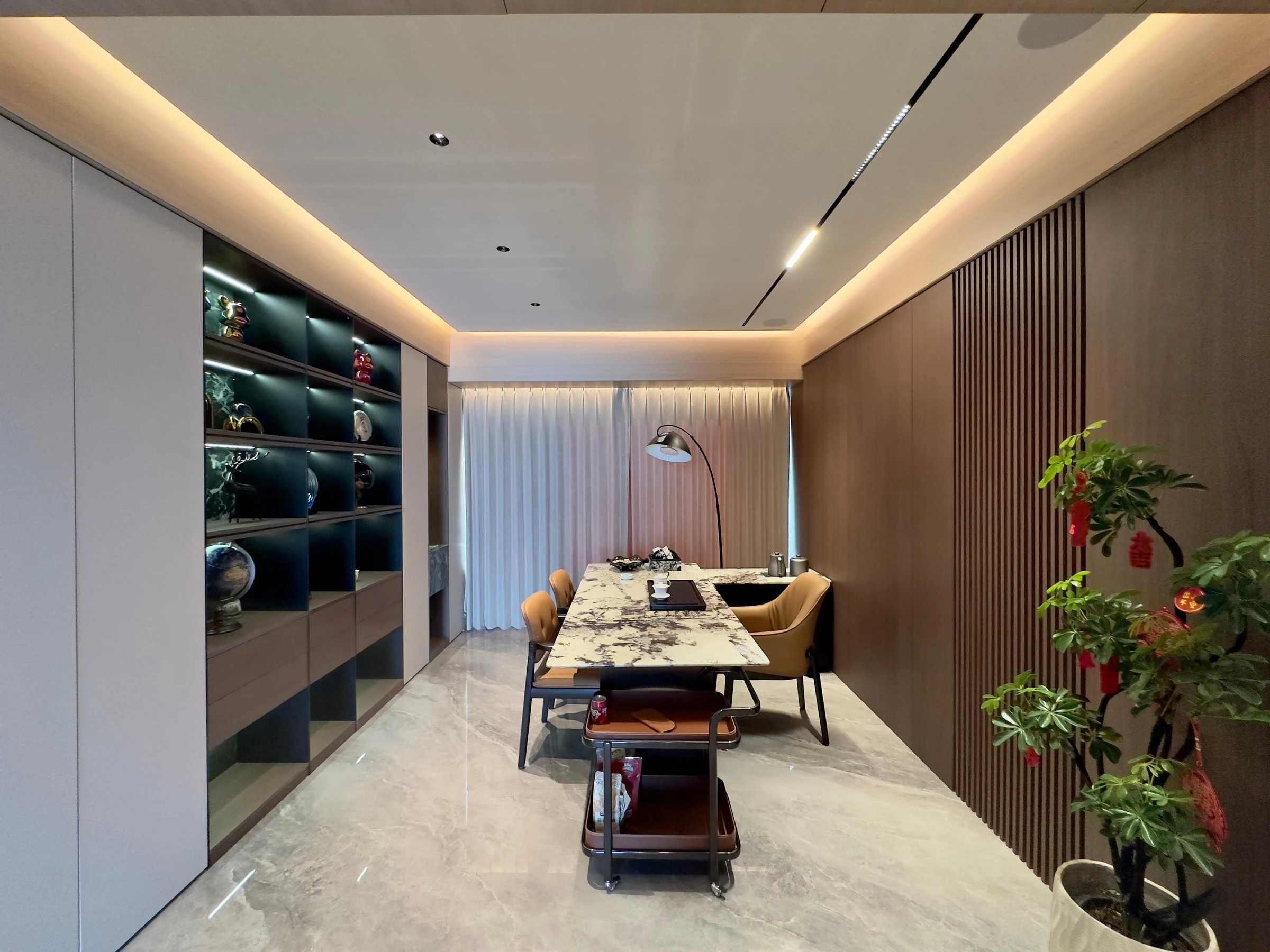 Shared dining space with full-height storage and illuminated display joinery