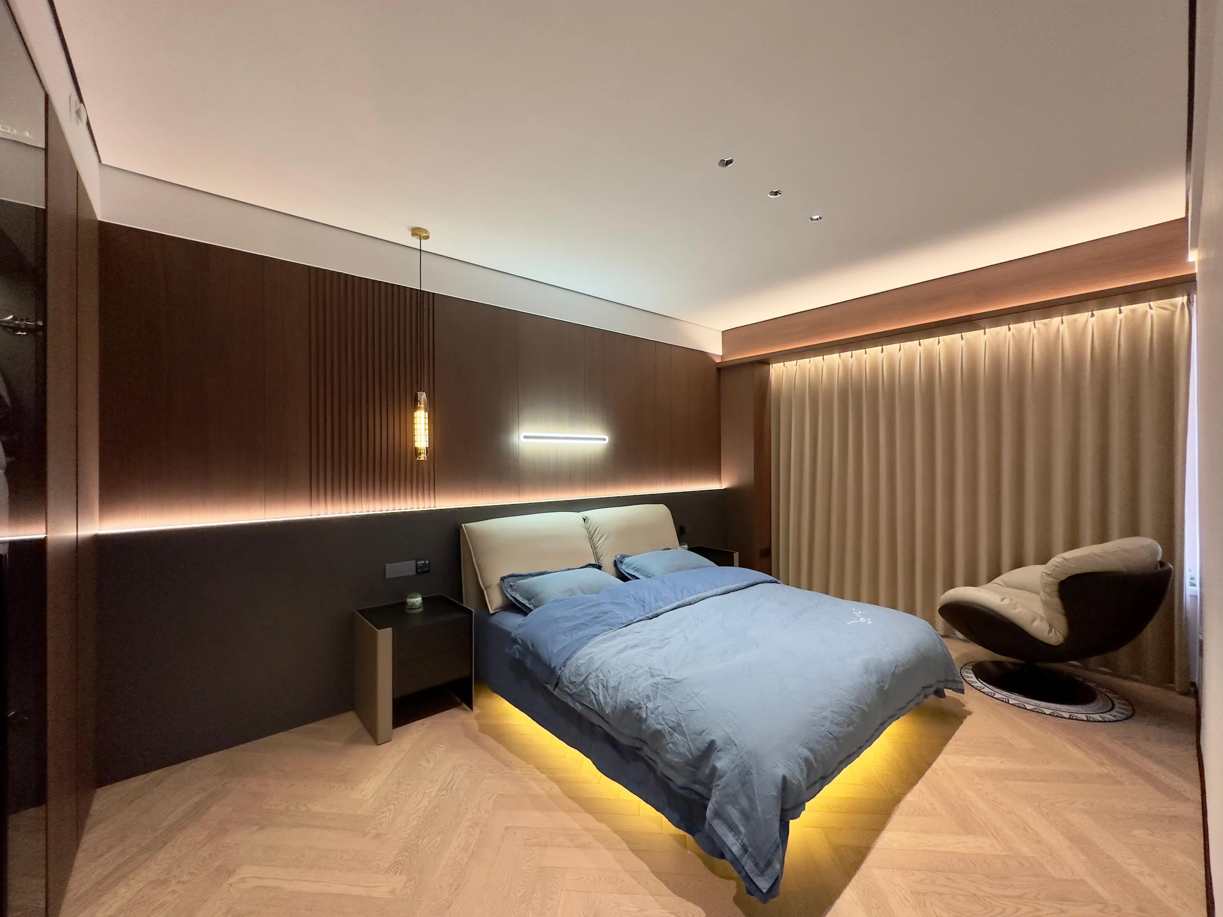 Bedroom with integrated wall panels and bedside joinery