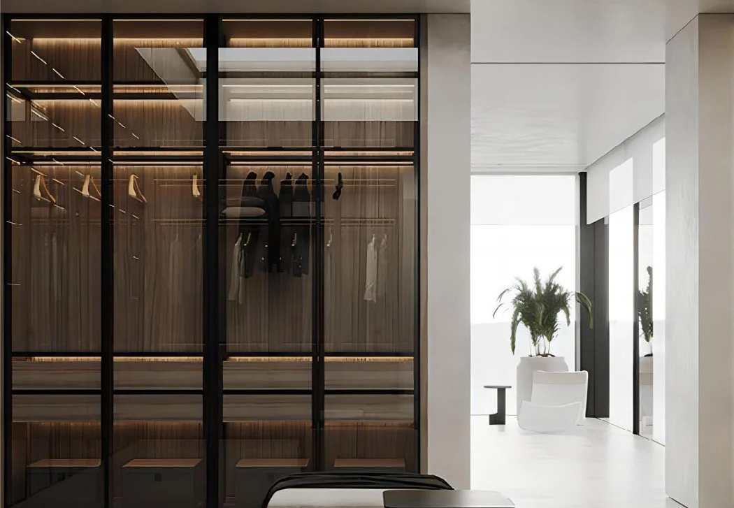 Glass-front fitted wardrobe with integrated lighting