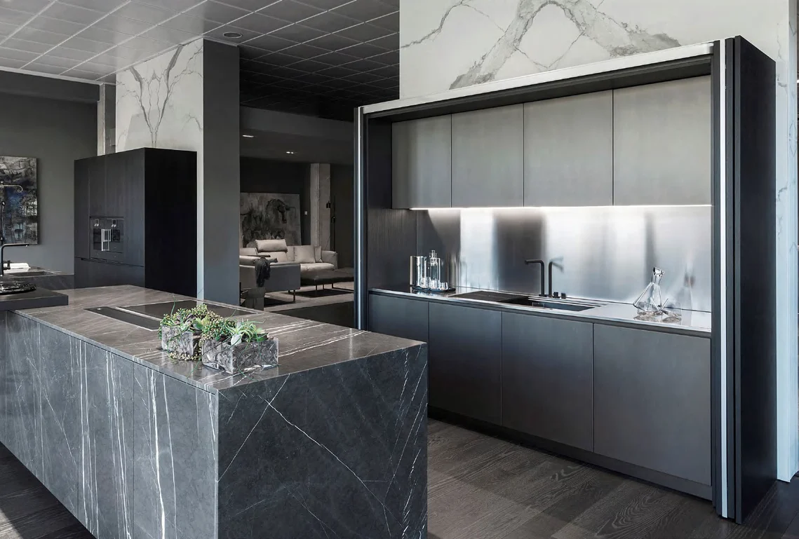 Dark cabinet wall and stone kitchen island showing material coordination