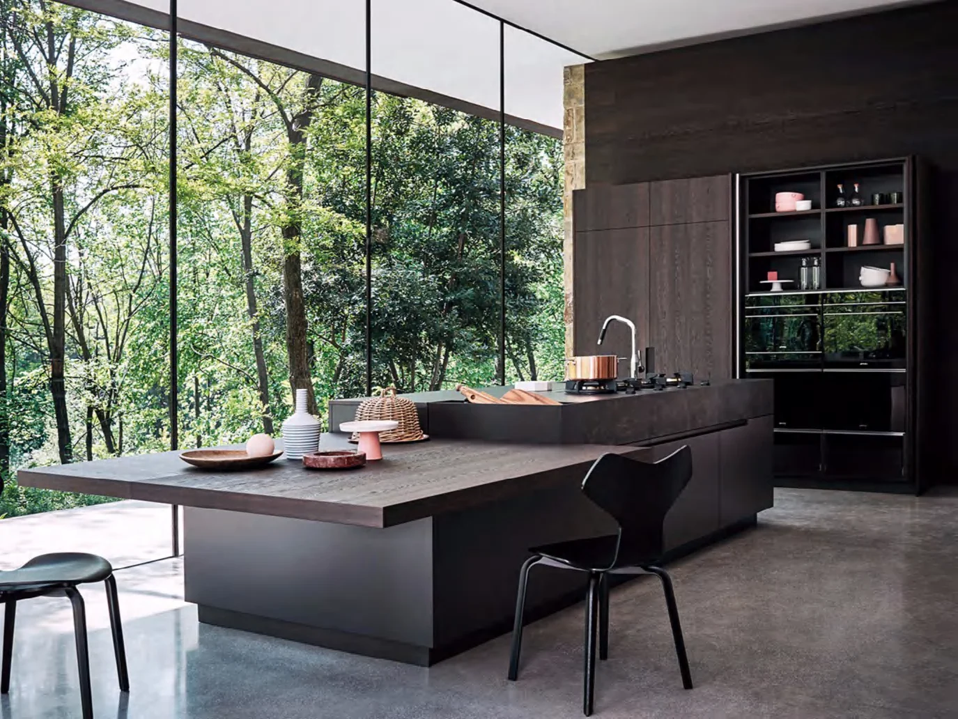 Kitchen island facing a forest view in a residential project