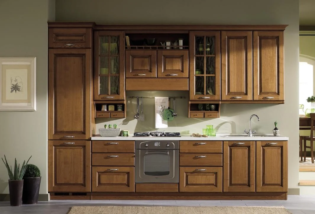Traditional solid wood kitchen cabinetry with raised door panels