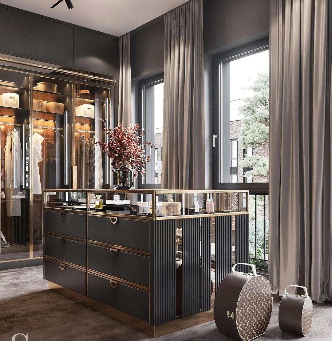 Walk-in closet with dressing island and illuminated cabinetry