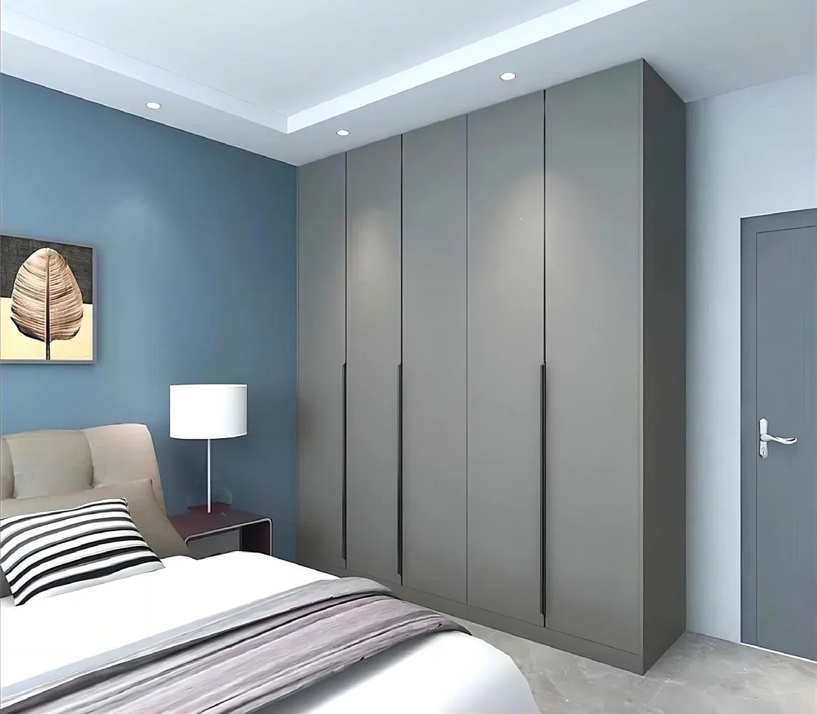 Hinged wardrobe doors open to organised hanging and drawer storage