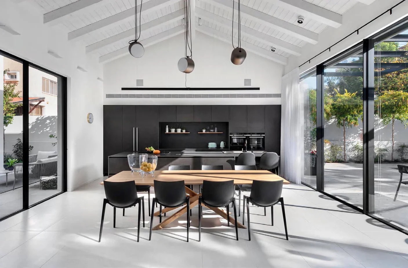 Contemporary black kitchen cabinetry in a bright open-plan room