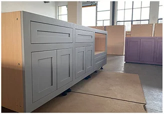 Assembled grey cabinet units on the workshop floor for inspection